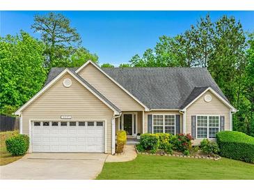 Charming ranch-style home with a well-manicured lawn and an attached two-car garage at 4219 David Austin Ct, Snellville, GA 30039