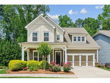 Charming two-story home with a beautifully landscaped front yard and attached garage at 2434 Soft Maple St, Atlanta, GA 30360