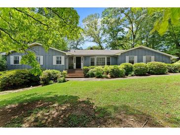 Charming one-story home with beautiful landscaping and mature trees in a lovely neighborhood at 3770 Clubland Trl, Marietta, GA 30068