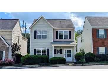 Charming two-story home featuring a welcoming front porch and neatly trimmed hedges at 3142 Imperial Sw Cir, Atlanta, GA 30311