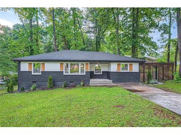 Charming single-story home featuring a well-manicured lawn and unique exterior design at 1722 San Gabriel Ave, Decatur, GA 30032