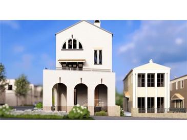 Charming new construction home featuring a white brick exterior, arched entry, and a stylish second-story balcony at 215 Rolison Way, Fayetteville, GA 30214