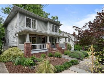 Charming two-story home with a welcoming front porch and professionally landscaped yard at 1066 High Point Ne Dr, Atlanta, GA 30306