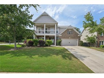 Charming two-story home featuring a double-decker porch, well-maintained lawn, and inviting curb appeal at 251 Parc Dr, Canton, GA 30114