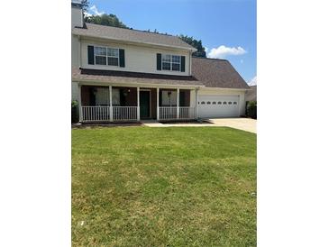 Charming two-story home with a welcoming front porch and well-manicured lawn at 421 Old Ivy Path, Mcdonough, GA 30253