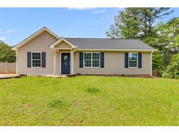Charming one-story home featuring a well-maintained lawn and classic curb appeal at 159 Cranbrooke Dr, Dallas, GA 30157