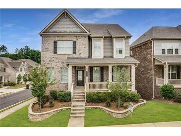 Charming two-story home with a brick facade, landscaped yard, and a welcoming covered front porch at 4831 Miller Hill Rd, Buford, GA 30518