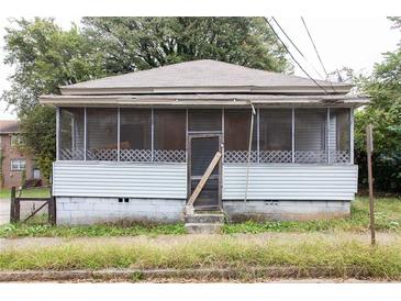 Modest single-story home with screened porch and weathered features, needing renovation at 108 Vine Sw St, Atlanta, GA 30314