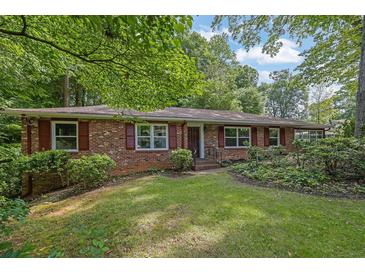 Charming single story brick home with well-manicured lawn and mature trees offering shade and curb appeal at 1981 Bramblewood Ne Dr, Brookhaven, GA 30329