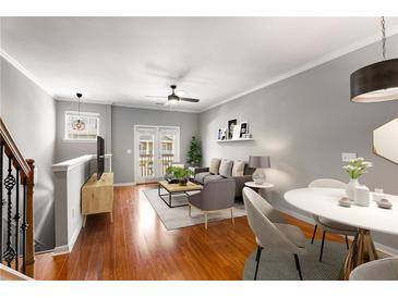 Bright living room featuring hardwood floors, modern furniture, and access to a private balcony at 2015 Liberty Nw Ct, Atlanta, GA 30318