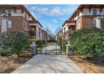 Brick building facade with gated entrance and professionally landscaped front yard at 746 N Highland Ne Ave # 7, Atlanta, GA 30306