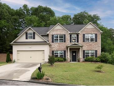 Charming two-story home with brick and siding, a well-manicured lawn, and an attached two-car garage at 5976 Rosie Se Ln, Mableton, GA 30126
