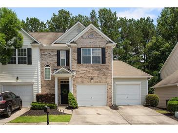 Charming townhome with a well-manicured lawn and an attached one car garage at 3313 Thornbridge Dr, Powder Springs, GA 30127
