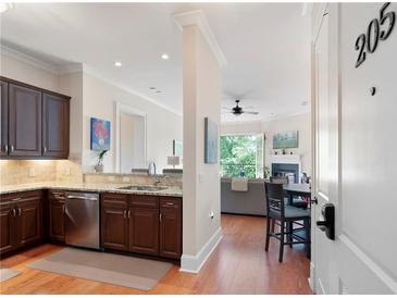 Modern kitchen with stainless steel appliances and granite countertops, open to the living area at 351 Washington Ne Ave # 205, Marietta, GA 30060