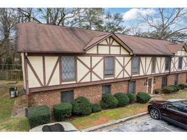 Charming Tudor-style building with brick accents and manicured landscaping at 3187 Abbeywood Dr, Decatur, GA 30034