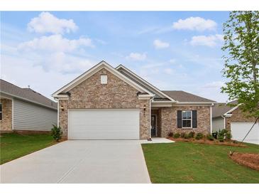 Charming one-story home featuring a brick facade, well-maintained lawn, and an attached two-car garage at 401 Village Ln, Fairburn, GA 30213