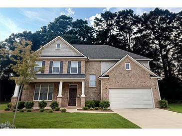 Beautiful brick two-story home featuring a two-car garage and well-manicured lawn at 1147 Halletts Peak Pl, Lawrenceville, GA 30044