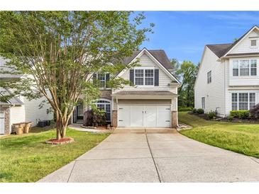 Charming two-story home featuring a well-manicured lawn, attached two car garage, and traditional design at 355 Pintail Ct, Suwanee, GA 30024