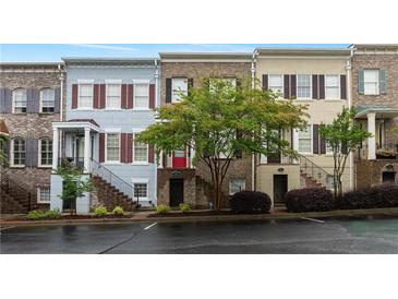 Charming townhomes featuring brick and siding exteriors, manicured landscaping and tree-lined street at 1003 Pearl Ne Pt, Sandy Springs, GA 30328