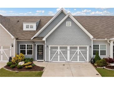 Charming townhome featuring a well-manicured front yard and a two-car garage at 117 Point View Dr, Canton, GA 30114