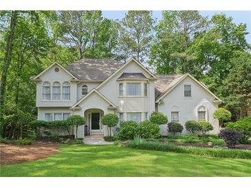 Charming two-story home features a well-manicured lawn and beautiful landscaping at 3780 Bays Ferry Way, Marietta, GA 30062