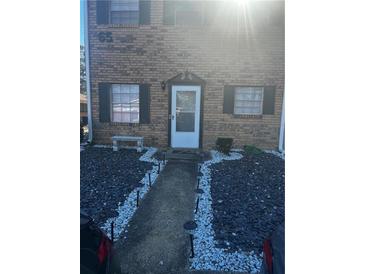 Charming brick home featuring a landscaped walkway and decorative lighting leading to a welcoming front door at 4701 Flat Shoals Rd # 65A, Union City, GA 30291