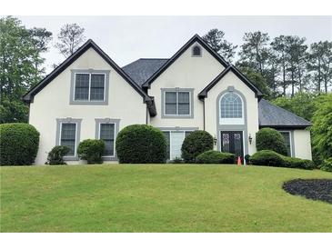 Charming two-story home with a manicured lawn, symmetrical windows and black shingle roof at 503 Chatfield Nw Way, Marietta, GA 30064