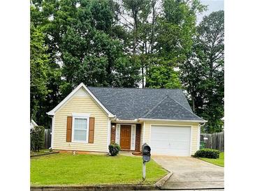 Charming yellow single-story home with an attached garage and well-manicured lawn at 3793 Mays Sw Ct, Atlanta, GA 30331