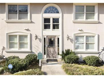 Charming condo building featuring an arched entryway, updated windows, and manicured landscaping at 1538 Chantilly Ne Dr # 224, Atlanta, GA 30324