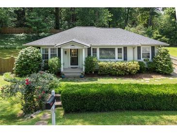 Charming single-story home with a well-manicured lawn, mature trees, and inviting curb appeal at 184 Rambo Sw Pl, Marietta, GA 30064