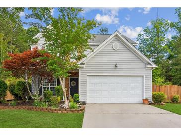 Charming two-story home features a well-maintained lawn, attached two-car garage, and mature landscaping at 2173 Beacon Crest Dr, Buford, GA 30519