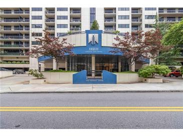 Ansley Above the Park entrance featuring modern architecture with mature trees and manicured landscaping at 1130 Piedmont Ne Ave # 803, Atlanta, GA 30309