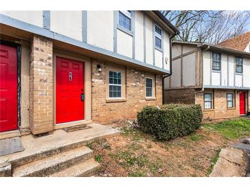Inviting townhome with a bright red front door and well-maintained brick facade at 1150 Rankin St # 6H, Stone Mountain, GA 30083