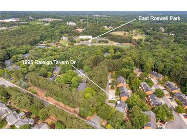 Stunning aerial view showcases the neighborhood and nearby park at 1995 Raleigh Tavern Dr, Roswell, GA 30076