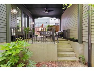 Inviting covered front porch with wrought iron railings and outdoor seating area for relaxing and entertaining at 262 Southerland Ne Ter, Atlanta, GA 30307