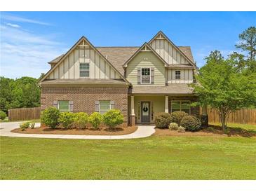 Charming two-story home featuring brick and siding accents, a well-manicured lawn, and a welcoming front porch at 237 Arborview Dr, Mcdonough, GA 30252