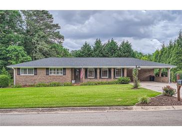 Charming brick home featuring a well-maintained lawn and inviting curb appeal at 5478 Janice Ln, Stone Mountain, GA 30087