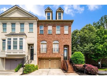 Charming brick townhome with a two-car garage and beautifully landscaped front yard at 3331 Vintage Se Cir, Smyrna, GA 30080