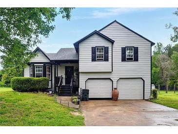 Charming two-story home boasts a well-maintained yard and a two-car garage at 18 Amanda Dr, Dallas, GA 30157