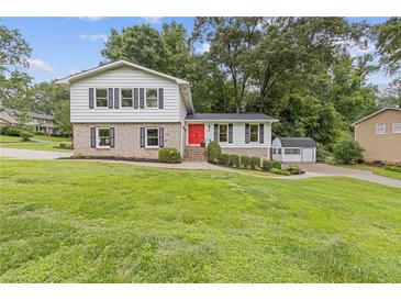 Charming two-story home featuring a bright red front door and well-maintained landscaping at 3751 Cherokee Se Pl, Marietta, GA 30067