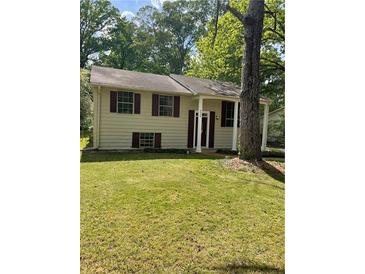 Charming home with a well-maintained lawn and mature trees in a serene and quiet neighborhood at 6399 Boca Grande Blvd, Forest Park, GA 30297