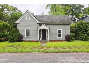 Charming one-story home with a welcoming front porch and well-maintained lawn at 1096 Tilden Nw St, Atlanta, GA 30318