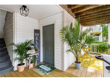 Inviting front door area with a welcome mat, plants, and a small table with 'HOME' decor at 1990 Wellbourne Dr # 5, Atlanta, GA 30324