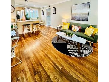 Inviting living room featuring hardwood floors, a stylish rug, and comfortable seating arrangement at 1990 Wellbourne Dr # 5, Atlanta, GA 30324