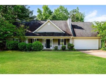 Charming single-story home with a welcoming front porch and well-maintained landscaping at 85 Chestnut Dr, Covington, GA 30016