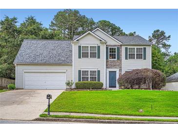 Charming two-story home featuring stone accents, manicured lawn, and an attached two-car garage at 1070 Evergreen Oak Way, Dacula, GA 30019