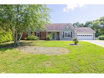 Charming single-story home with a well-manicured lawn and an attached two-car garage at 1490 Twin Manor Dr, Loganville, GA 30052