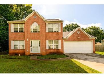 Charming brick two-story home with a well-manicured lawn and an attached two-car garage at 3730 Warriors Path, Decatur, GA 30034