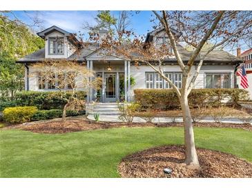 Charming two-story home with landscaped yard and inviting front porch and dormer windows at 1466 University Dr, Atlanta, GA 30306