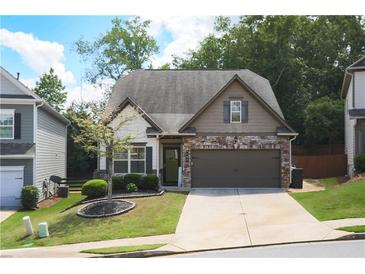 Charming home with stone accents, well-manicured lawn, and inviting curb appeal at 103 Prominence Ct, Canton, GA 30114